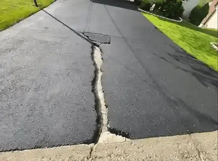 Close view of long crack in asphalt road surface