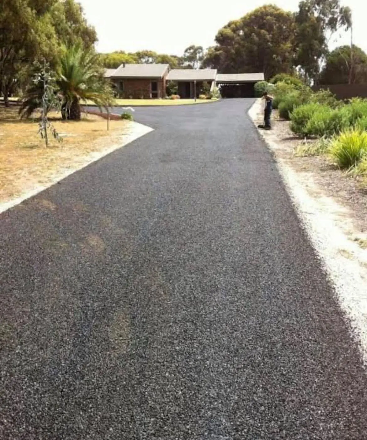 Asphalt driveway leading to residential house