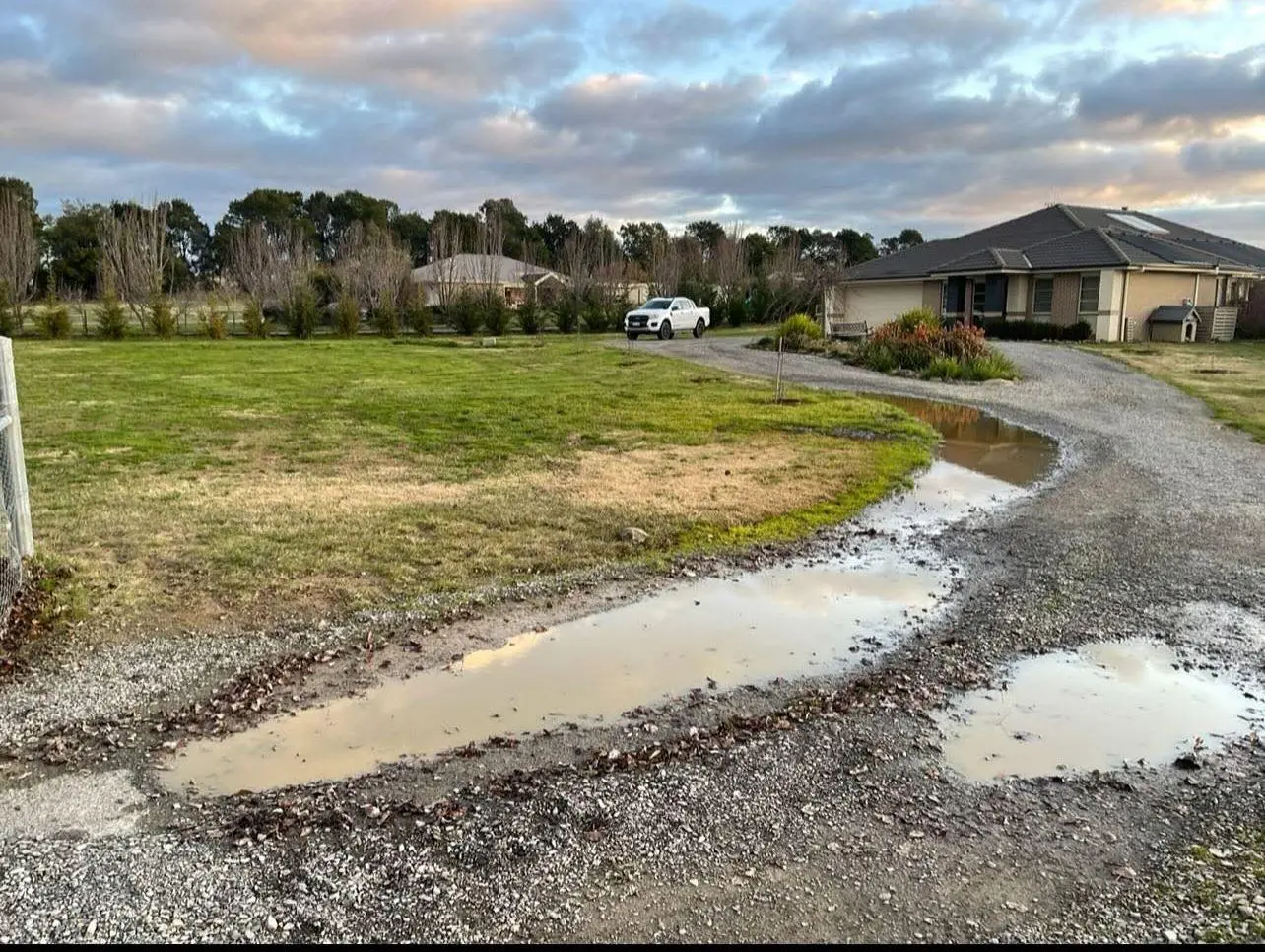 Rural road with patches and water damage spots